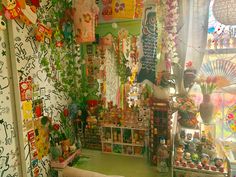 a room filled with lots of different items and decorations on the walls, including toys