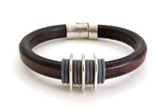 a brown leather bracelet with silver accents