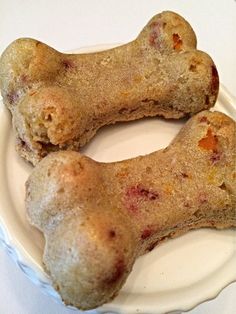 two dogs bone shaped treats on a white plate