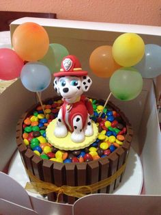 a birthday cake in the shape of a fireman's dog with balloons on top