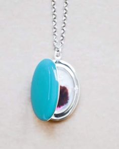 This large enameled locket will be a unique tribute to your personal style. With a long pendant style length, this is also great for layering with other necklaces. Enameled in the color of your choice, this necklace is both lovely to look at & lovely to hold. By adding a special photo, personalized stamps or charms, this locket necklace will be a piece of jewelry you'll always want to wear.  ITEM DETAILS  * Large Silver Plated oval locket measures 29mm (1 inch) * Hand enameled in the color of yo Oval Enamel Locket Jewelry, Oval Enamel Locket Necklace, Oval Locket Necklace In Enamel, Blue Oval Locket Necklace, Oval Blue Locket Necklace, Blue Medallion Locket Necklace As Gift, White Oval Pendant Locket Necklace, Oval Pendant Locket Necklace As A Gift, Oval Locket