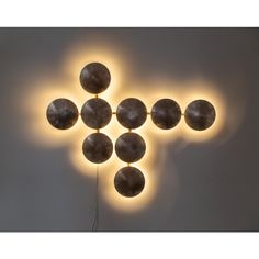 a wall mounted light fixture with eight balls on it's sides and four lights in the middle