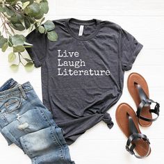 Live laugh literature shirt. Funny gift for a literature student. Premium crafted soft & comfy unisex tee. Best fit. Best feel. * Premium quality soft and lightweight shirt with the right amount of stretch. * Fast delivery. * Unisex design! Comfortable and flattering for both men and women. * Customization and more colors available -- send us a message with your request. * Most people are happy ordering their regular size, but some people might need to order a size up or down! Please check the s Literary Cotton T-shirt With Text Print, Literary Cotton Relaxed Fit T-shirt, Literary Style Cotton T-shirt With Relaxed Fit, Literature Student, Literature Gifts, Student Shirt, English Major, Club Ideas, Book Lover