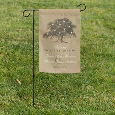 a wedding sign in the grass with a tree and stars on it's back