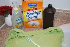 the contents of a diaper sitting on top of a counter next to a bottle of baking soda