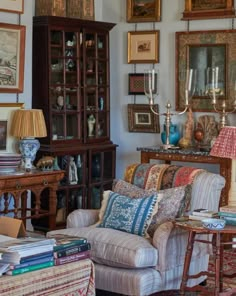 a living room filled with furniture and pictures on the wall