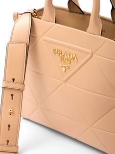 Prada beige leather bag. Featuring a stitched triangle motif, leather handles, detachable and adjustable shoulder strap, removable leather keychain inside, metal hardware and Prada nylon logo lining with two pockets, one with a zipper.