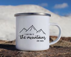 a white enamel mug with the words i love back to the mountains and back printed on it