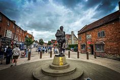 a statue is in the middle of a town square