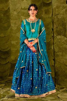 Deep lagoon blue lehenga with silk tape, aari, zari and silk thread embroidery. Paired with a lapis green embroidered long blouse and a circular butti embroidered dupatta. - Aza Fashions Blue Dola Silk Pre-draped Saree For Eid, Festive Blue Art Silk Pre-draped Saree, Blue Pre-draped Saree With Sheer Dupatta For Festivals, Transitional Blue Pre-draped Saree With Unstitched Blouse, Blue Fitted Pre-draped Saree For Transitional Season, Blue Silk Lehenga For Reception, Transitional Blue Silk Pre-draped Saree, Blue Dola Silk Pre-draped Saree With Pallu, Unstitched Blue Set With Blouse