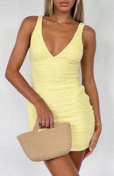 Summer dresses don't get cuter than this... The Got Her Own Mini Dress Lemon is a mini dress made for sunny summer days. Features a plunge neckline, crinkle fabric, lined fabric, mini length, thick straps, slip-on style and lined fabric. Pair with a thong heel and a mini bag for a chic look! - 65% Polyester 30% Cotton White Mini Dress Classy, Cute Unique Hoco Dresses, Casual Hoco Dresses, Yellow Dress With Flowers, Red Hoco Dress, College Events, Short Yellow Dress, Summer Wishlist, Teen Style