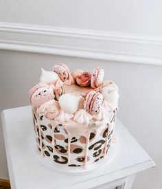 a decorated cake sitting on top of a white table