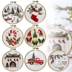 six cross stitch christmas ornaments hanging on the wall in front of a christmas tree and fire hydrant