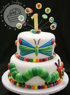 a very cute looking cake with some decorations on it's top and the number one