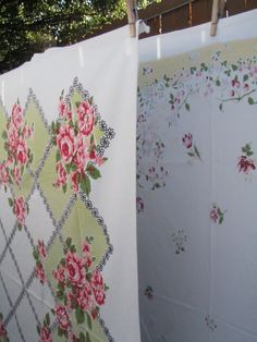 two quilts are hanging on a clothesline outside in the sun and one is covered with flowers