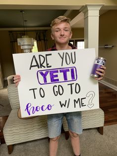 a man holding a sign that says are you yet to go to provo wme?