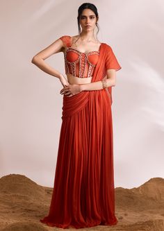 Let the allure of stone adornments and impeccable pleats sweep you away into the modern glamour. Perfect for various opulent celebrations, our ignis saree set includes a figure-accentuating corset blouse and a concept drape saree. Designer Fitted Pre-draped Saree For Wedding, Designer Fitted Pre-draped Saree For Designer Wear, Designer Wear Fitted Pre-draped Saree, Designer Pre-draped Saree With Unstitched Blouse For Wedding, Designer Fitted Pre-draped Saree, Designer Pre-draped Saree With Zari Work For Reception, Designer Pre-draped Saree For Wedding, Designer Saree For Reception With Traditional Drape, Designer Cutdana Pre-draped Saree For Weddings