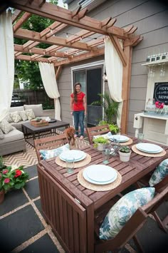 a woman standing in front of a table with plates on it