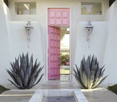 the entrance to a house with pink and white walls