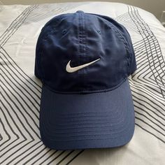 Nike Hat Classic Blue Sports Hat, Nike Baseball Cap, One Size Fits Most, Nike Casual Visor Hat, Casual Nike Visor Hat, Casual Nike Flat Brim Hat, Classic Nike Baseball Cap, Blue Sports Hat With Short Brim, Blue Short Brim Sports Hat, Nike Hat