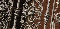 an iron gate with ornate designs on it