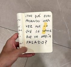 a hand holding an open notebook with writing on it and the words for one exit are written in spanish