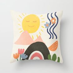 a pillow with an image of a sun, clouds and flowers on the front side