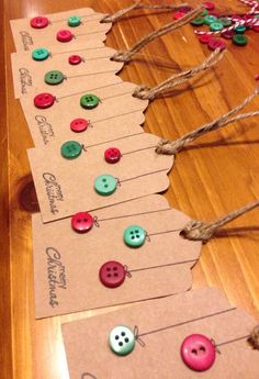 several different colored buttons are attached to twine on paper tags that hang from the floor