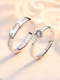 two silver rings with heart and i love you written on the sides, one has a diamond