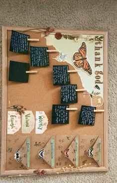 a bulletin board with several pieces of paper on top of it and a butterfly flying over them