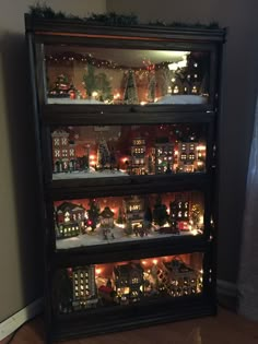 a lighted display case filled with lots of christmas decorations and lights on top of it