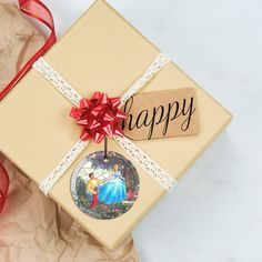 a gift wrapped in brown paper with a red ribbon and tag that says happy on it