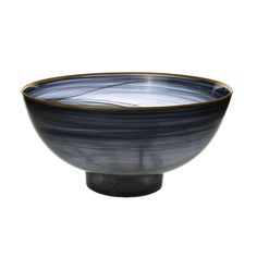 a black and white bowl sitting on top of a table