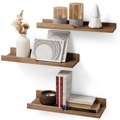 two wooden shelves with books and vases on them