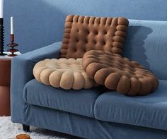 a blue couch with pillows on it in a living room