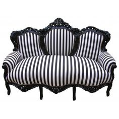 a black and white striped couch sitting on top of a wooden frame