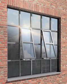 a brick building with several windows on each side and sky in the window sill