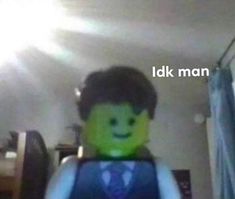 the lego man is wearing a vest and tie