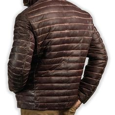 Rugged style meets winter warmth in our Men's Brown Leather Puffer Jacket. Crafted from supple, genuine leather with a rich brown hue, this jacket features quilted puffer insulation for superior heat retention. The classic silhouette is enhanced with a stand-up collar, zippered front, and snug cuffs to keep the cold at bay. Practical side pockets provide storage and hand-warming comfort. Perfect for the fashion-conscious man who doesn't compromise on functionality, this jacket seamlessly transitions from outdoor adventures to city streets. Key features: Premium brown sheepskin leather exterior for durability and style Quilted puffer design for superior insulation Adjustable hem to seal out cold air Multiple pockets for convenient storage Satin lining for a luxurious feel Premium YKK zipper Biker Shirts Women, Spiked Leather Jacket, Mens Leather Blazer, Motorcycle Leather Vest, Racer Jackets, Biker Accessories, Flannel Vest, Varsity Jacket Women, Brown Puffer