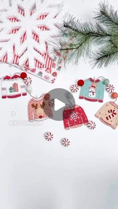 an ornament hanging from a christmas tree with candy canes and snowflakes