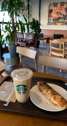 there is a coffee and pastry on the tray