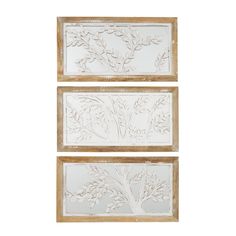 two white wall hangings with leaves and branches on the sides, one is made out of wood