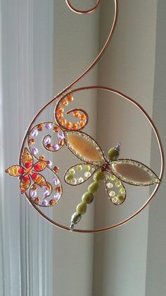 a decorative wind chime hanging from a window