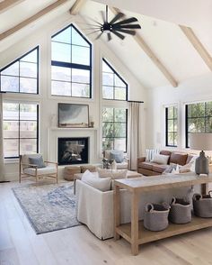 a living room filled with furniture and a fire place in the middle of a room