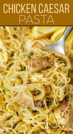 chicken caeser pasta in a white bowl with lemon wedges