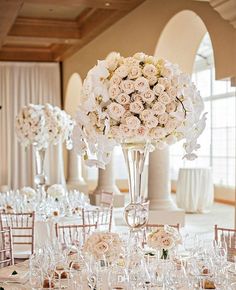 the centerpieces are filled with flowers and wine glasses for an elegant wedding reception