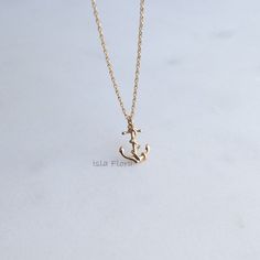 "Stunning 18k Gold Dipped Anchor Necklace. Detailed depiction of a rope intertwining and wrapping the anchor. Skillfully crafted, this necklace features a captivating anchor pendant, symbolizing strength, stability, and a love for maritime adventures. -18k Gold Dipped * Brass Casting * Lead & Nickel Free MEASURES * Necklace Length: 16\" with a 2-inch extender chain * Pendant Width: 0.5\" * Pendant Height: 0.4\" * Closure: Lobster Claw CARE: * Treat delicately to extend its life. Clean only with Ocean Minimalist, Anchor Jewelry, Nautical Necklace, Ocean Inspired Jewelry, Anchor Pendant, Anchor Charm, Anchor Necklace, Jewelry Bridesmaid, Casual Jewelry