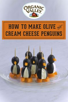 how to make olive cream cheese penguins on a clear plate with an orange sign in the background