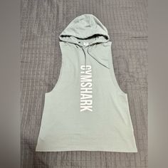 Gymshark Hoodie Mens Medium Pullover Sweatshirt Ripped Sleeveless Gym Training Green Color Brand New Without The Tag 60% Polyester 35% Cotton 5% Elastane Casual Sports Vest Top, Cotton Sportswear Vest For Streetwear, Casual Hooded Tank Top For Sports, Green Sleeveless Tank Top For Light Sports, Cotton Gym Top With Drawstring Hood, Casual Hooded Workout Vest, Sleeveless Cotton Hoodie For Gym, Sleeveless Cotton Hoodie For The Gym, Green Sleeveless Athletic Tops