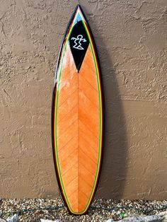 a surfboard leaning up against a wall